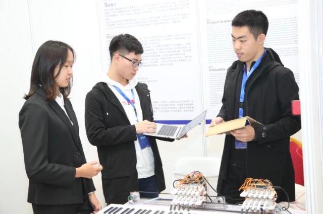 北航必赢565net官网网站学生韩腾飞,带来其团队研发的会弹钢琴的机械手。(中关村管委会供图)